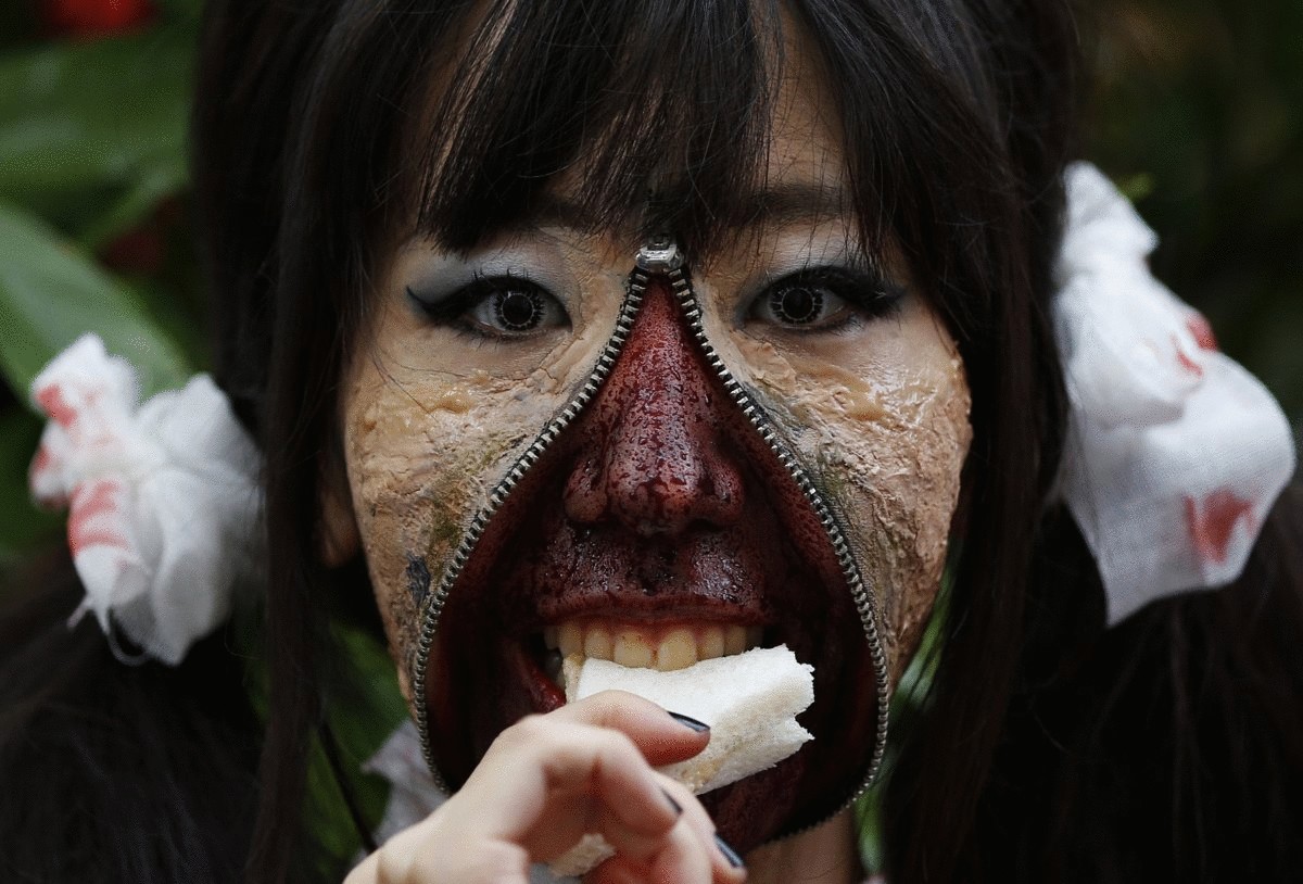 a-participant-in-costume-eats-a-sandwich-after-a-halloween-parade-in-kawasaki-south-of-tokyo-on-oct-26-more-than-100000-spectators-turned-up-to-watch-the-parade-where-2500-participants-dressed-up-in-costumes